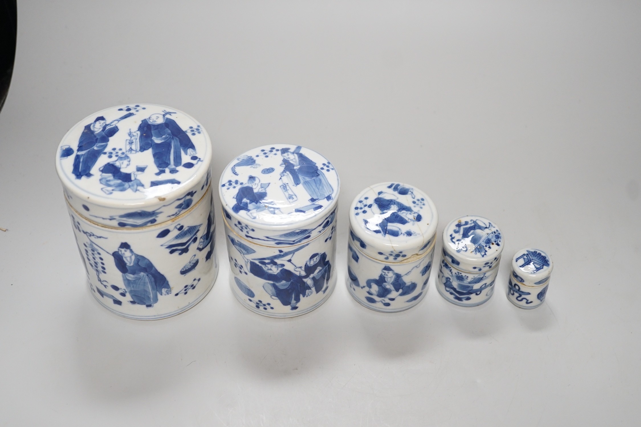 A set of four 19th century Chinese graduated blue and white jars and covers and a small jar with another design (5). Tallest 12cm